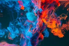 Abstract image. Colorful smoke with a dark background. Photo.